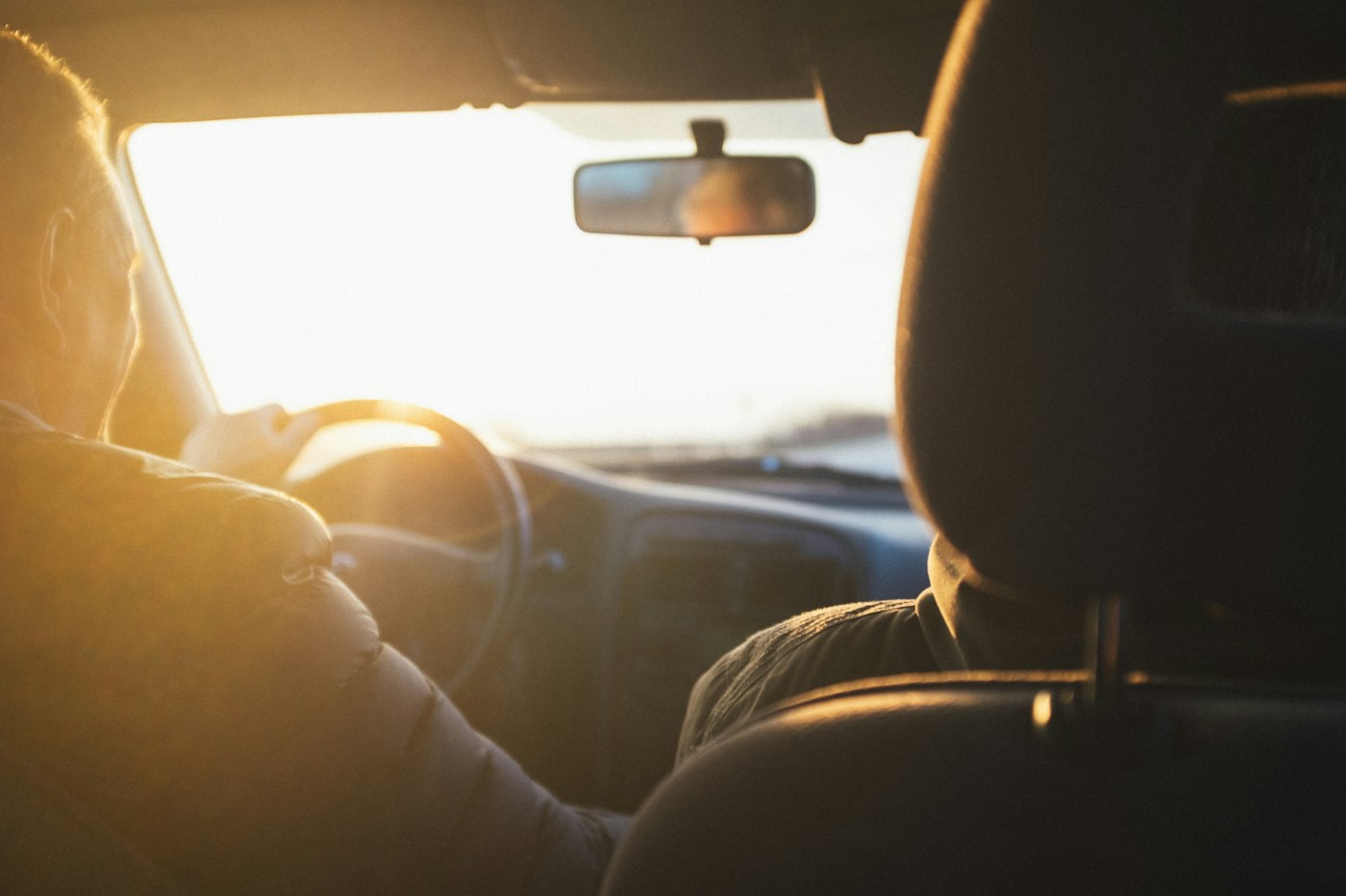 Person driving to work while struggling to keep up with auto loan payments
