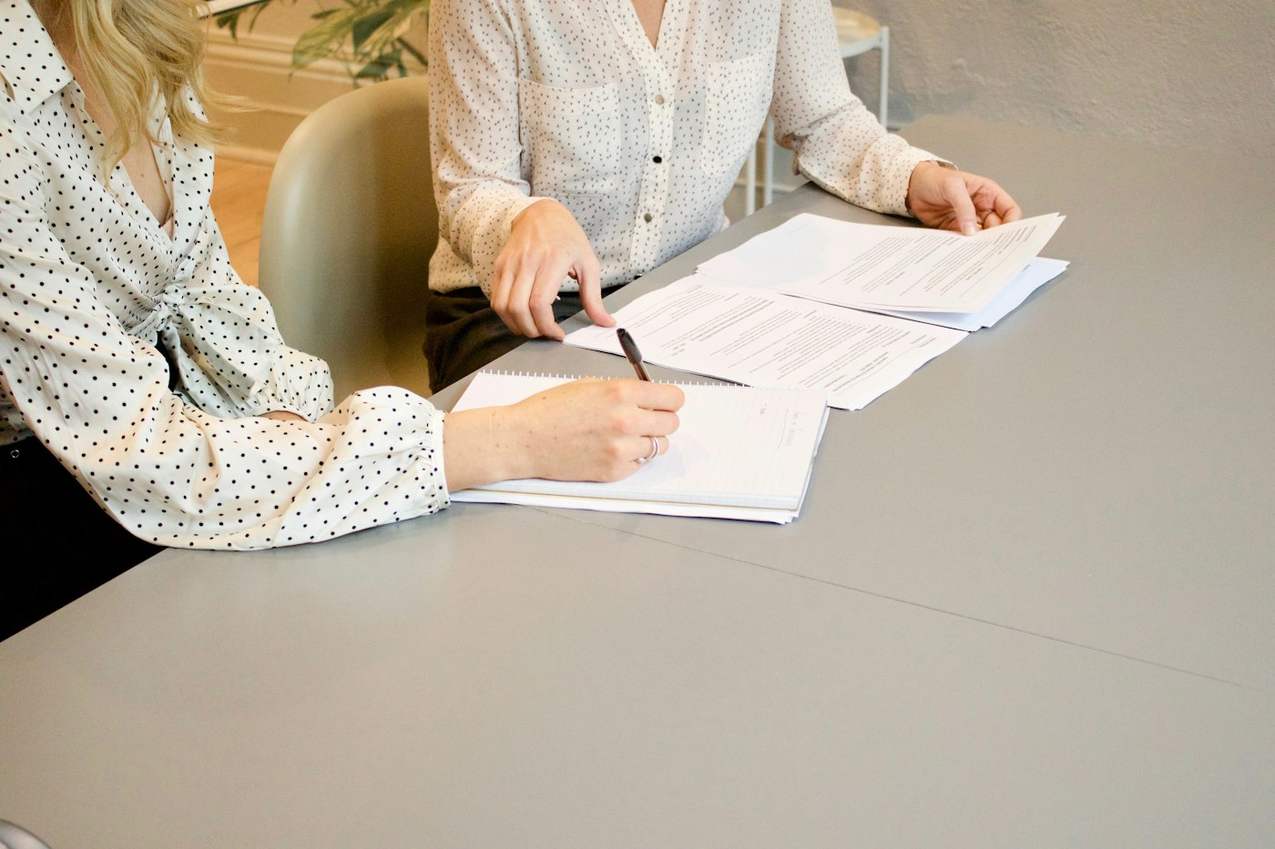 Person signing documents during a consultation with a Licensed Insolvency Trustee